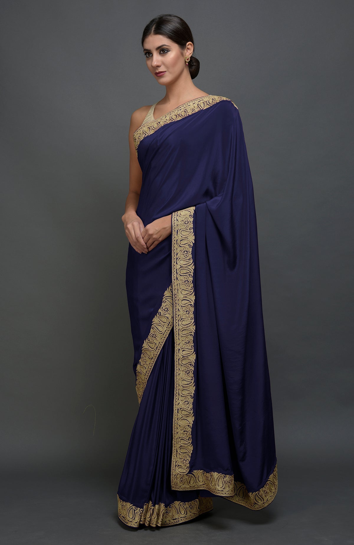 Navy blue pure crepe saree with gold paisley tilla aari embroidered borders.