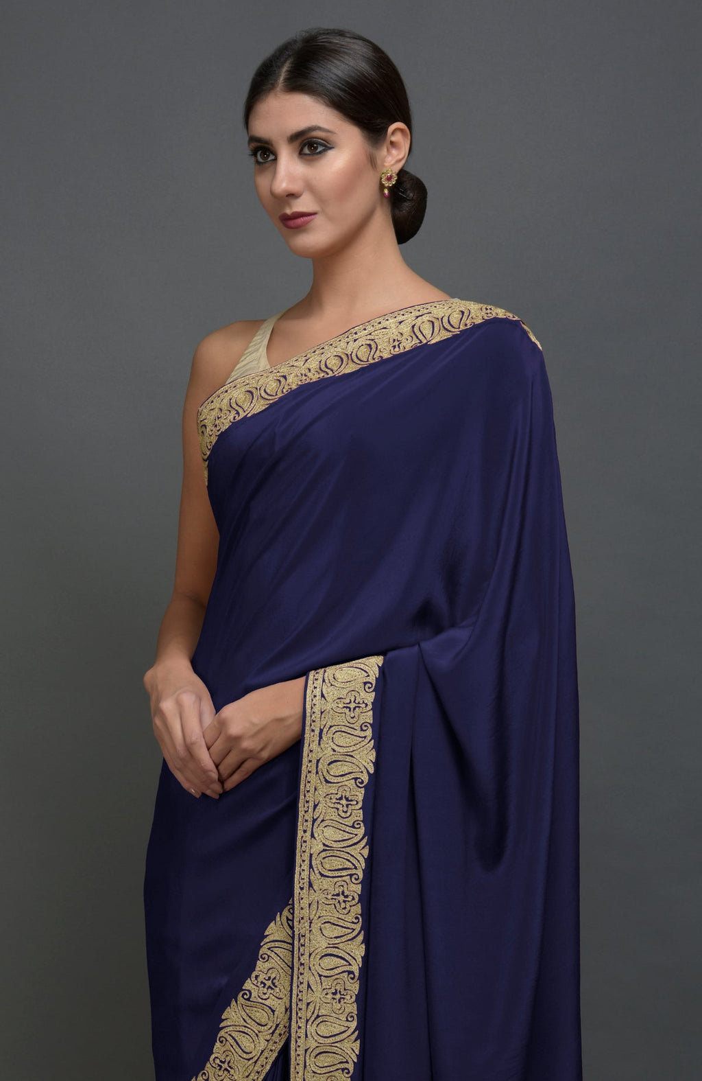 Navy blue pure crepe saree with gold paisley tilla aari embroidered borders.