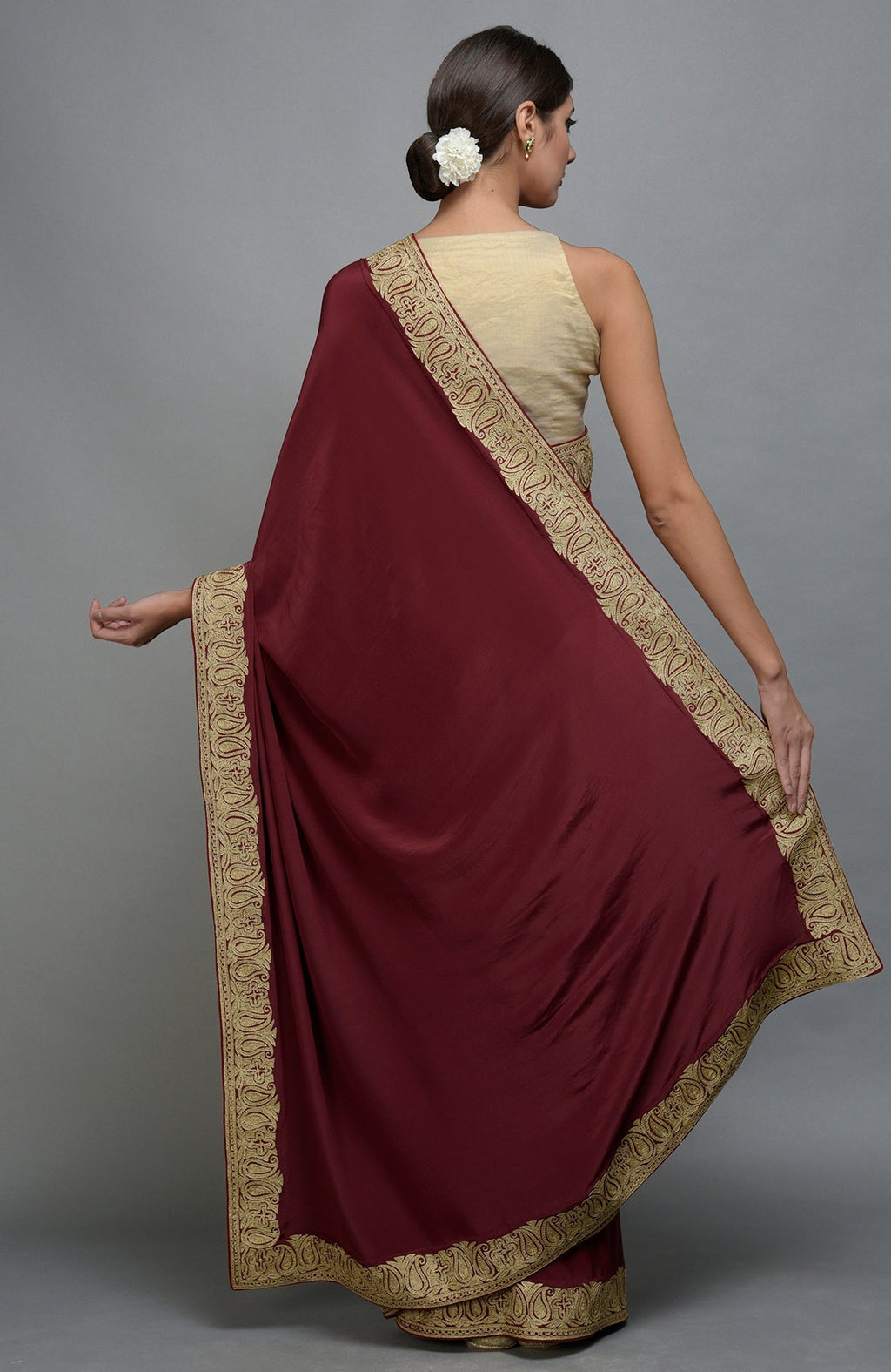 Maroon pure crepe saree with gold paisley tilla aari embroidered borders.