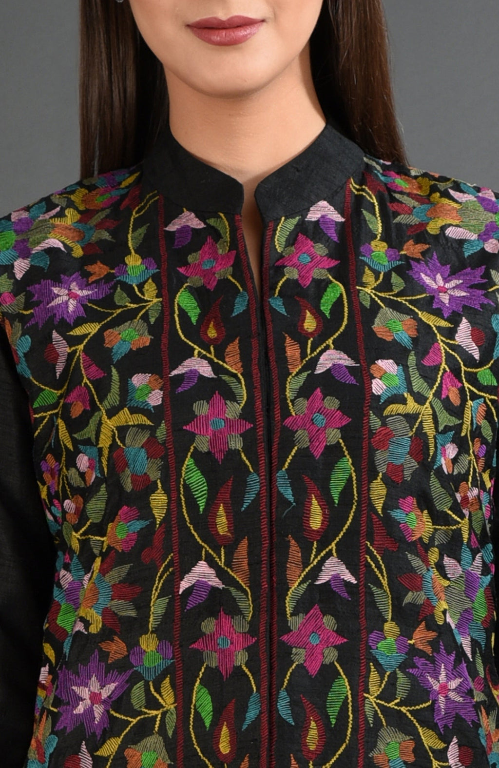 Black jacket with colorful floral embroidery and a band collar.