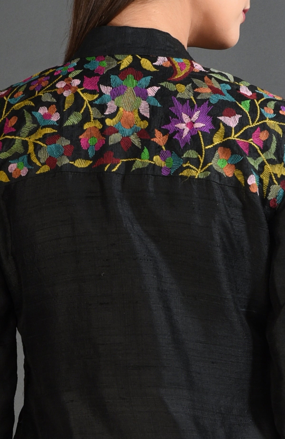 Black raw silk jacket with colorful floral Kani art embroidery on the back yoke.
