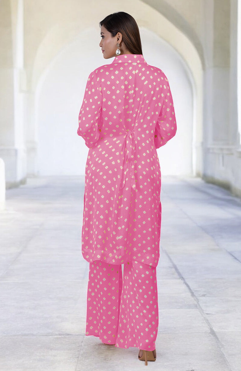 A woman models a pink bandhej embroidered co-ord set with matching pants.