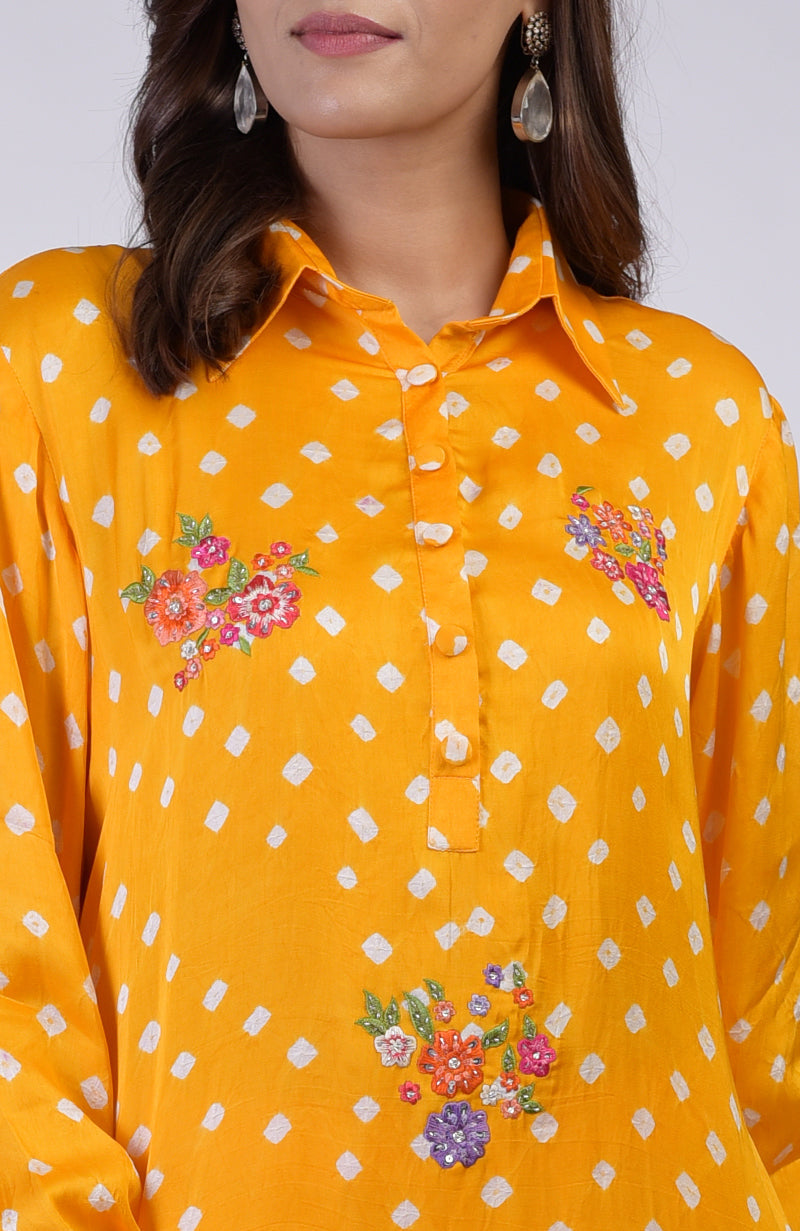 Turmeric yellow bandhej co-ord set with floral embroidery and a collared neckline.
