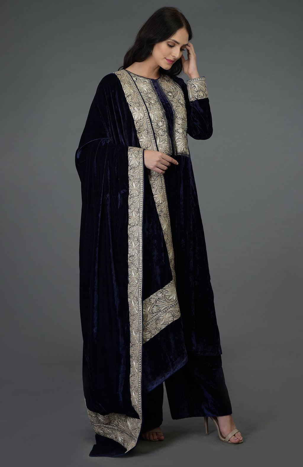 Woman in a midnight blue velvet suit with silver Tilla embroidery.