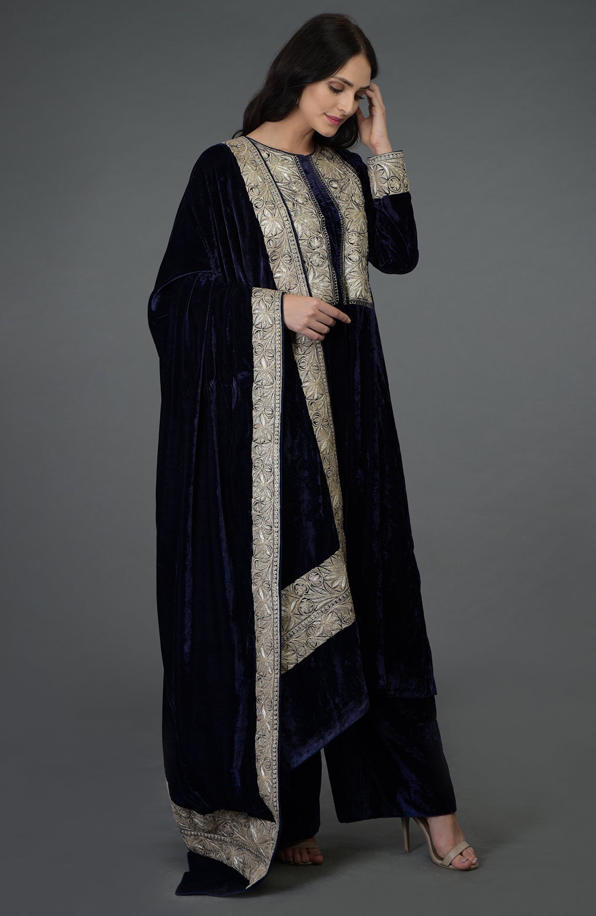 Woman in a midnight blue velvet suit with silver Tilla embroidery.