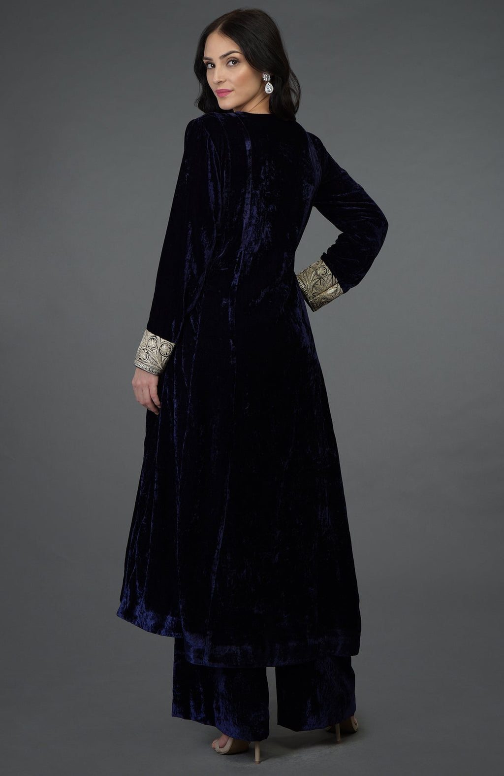 A woman models a midnight blue silk-velvet suit with Kashmiri Tilla embroidery.