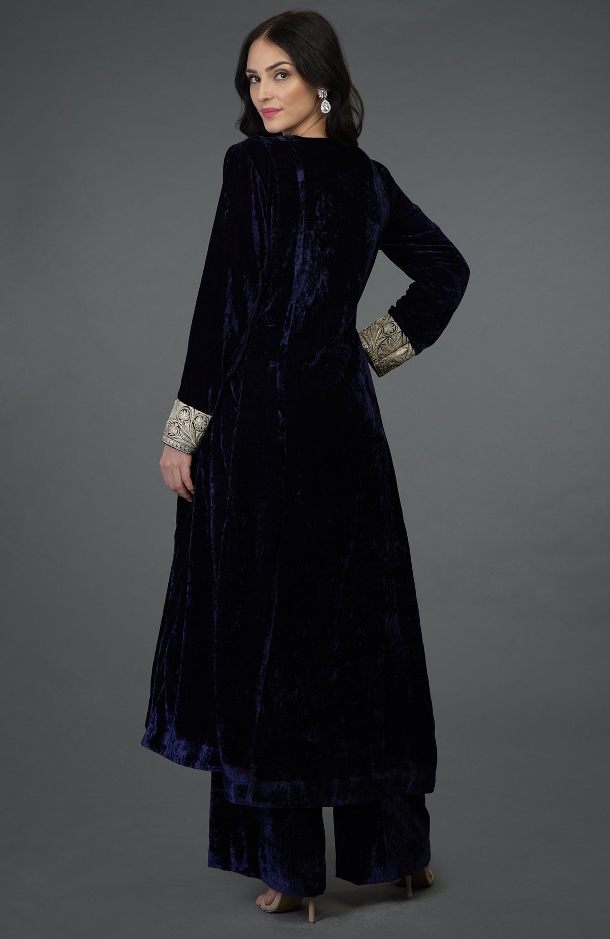 A woman models a midnight blue silk-velvet suit with Kashmiri Tilla embroidery.