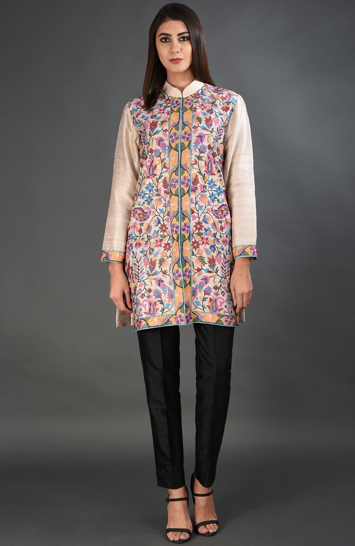 Creamy beige Kashmir Kani art embroidered jacket with black pants and heels.