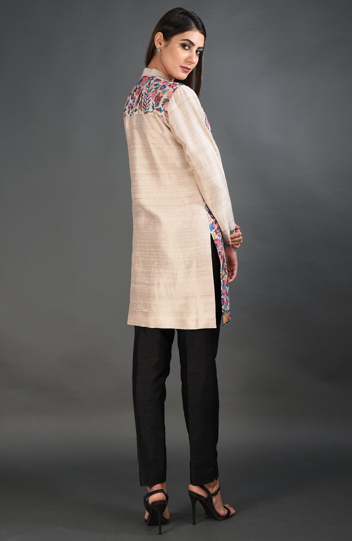 Creamy beige Kashmir Kani art embroidered jacket with black pants and heels.