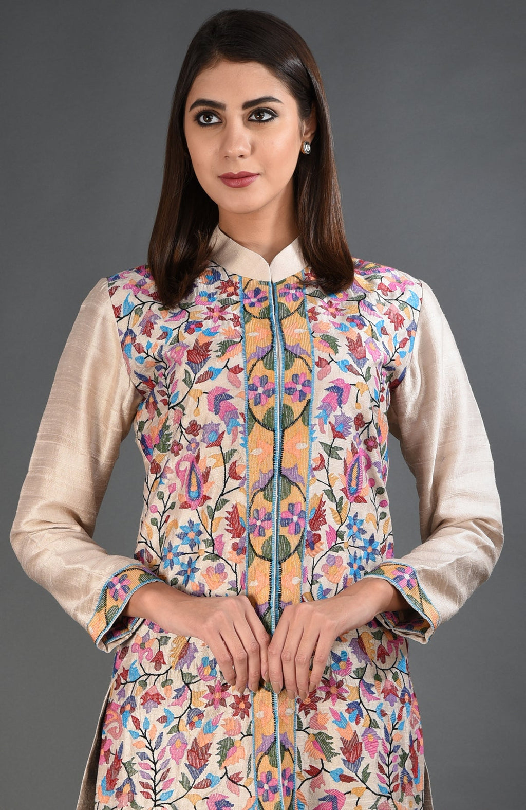 Creamy beige jacket with colorful floral and paisley embroidery.