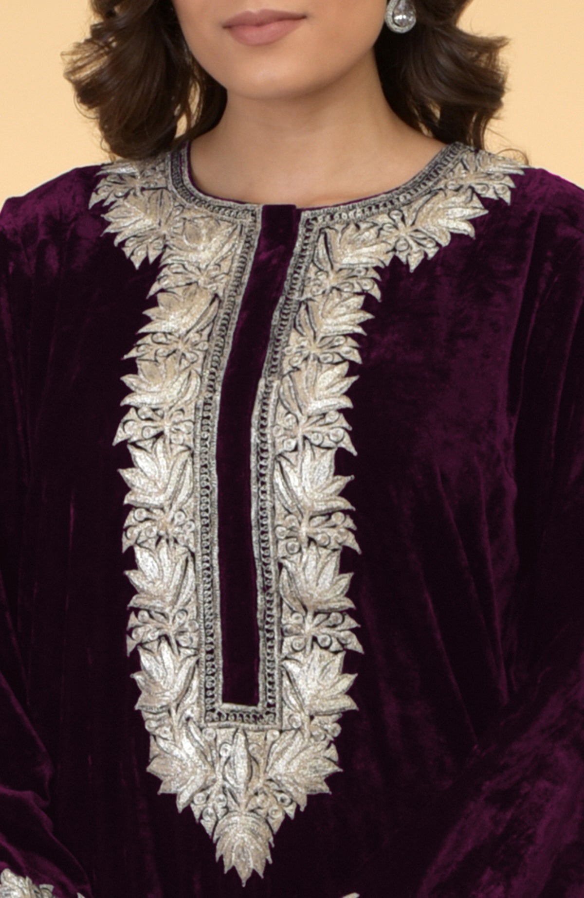 Plum velvet kaftan with silver Kashmir embroidery on the neckline and front opening.