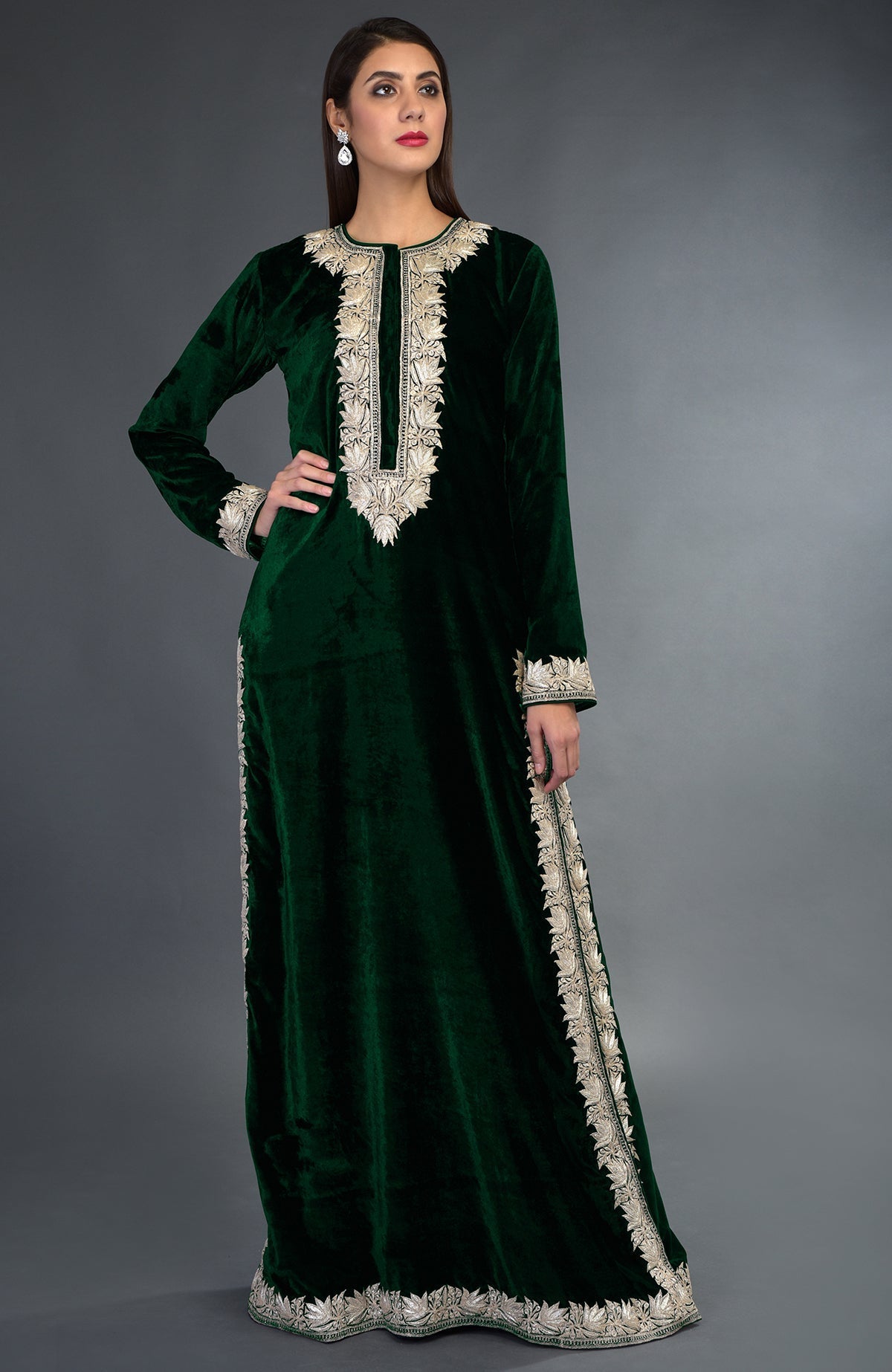 A woman models an emerald green velvet suit with silver tilla embroidery.