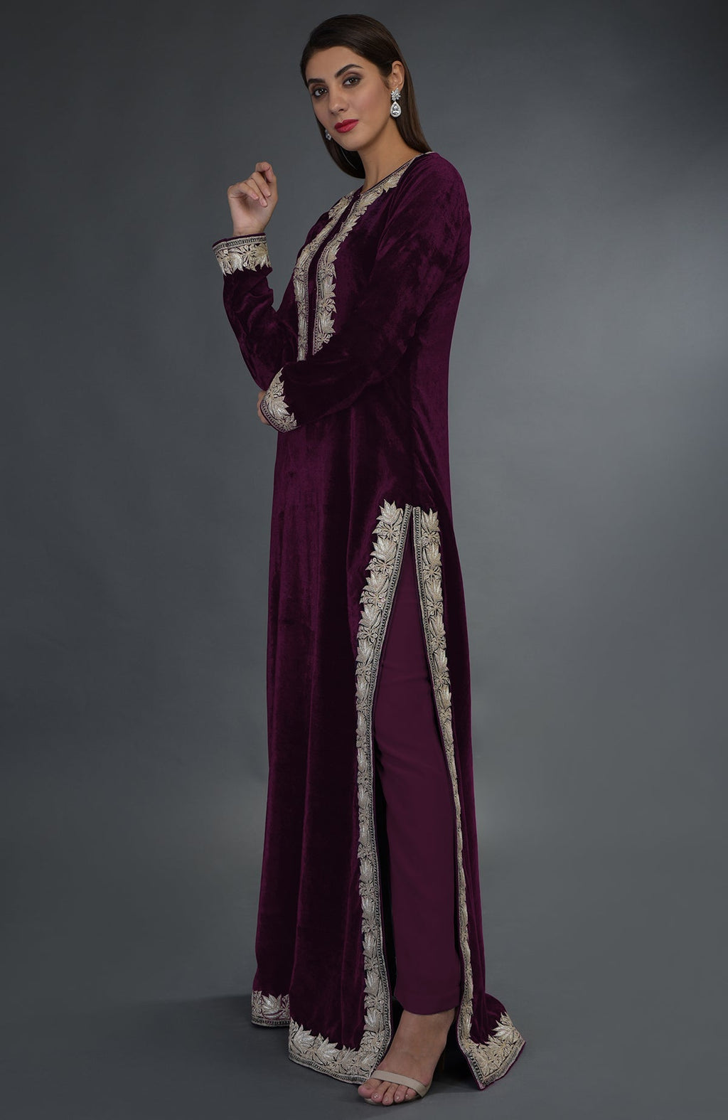 A woman models a plum velvet suit with silver tilla embroidery and matching pants.