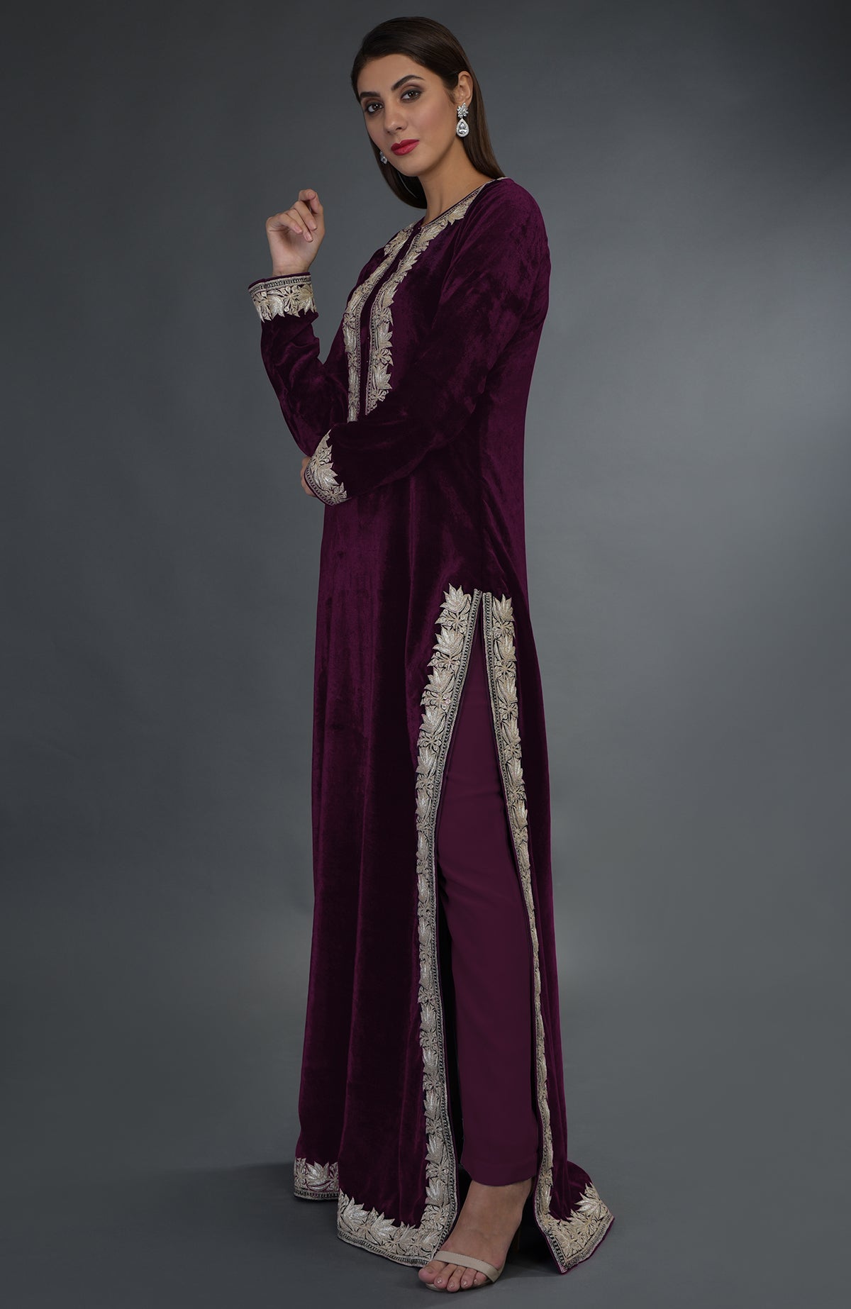 A woman models a plum velvet suit with silver tilla embroidery and matching pants.