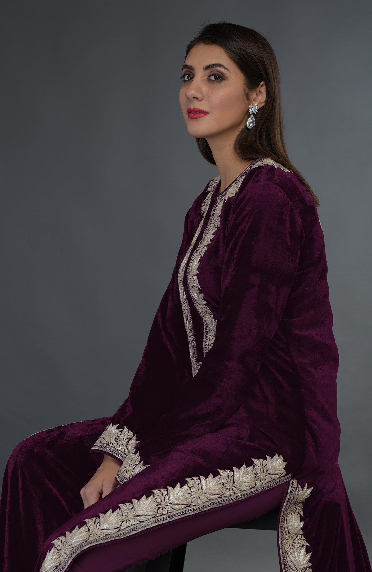 Plum velvet suit with silver tilla embroidery, worn by a woman.