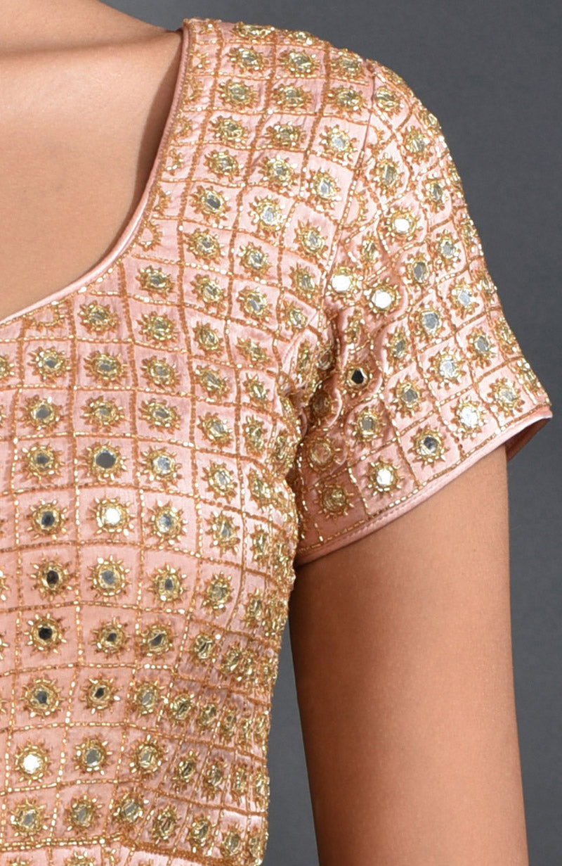 Pearl pink blouse with mirror and zardozi hand embroidery in a lattice pattern.