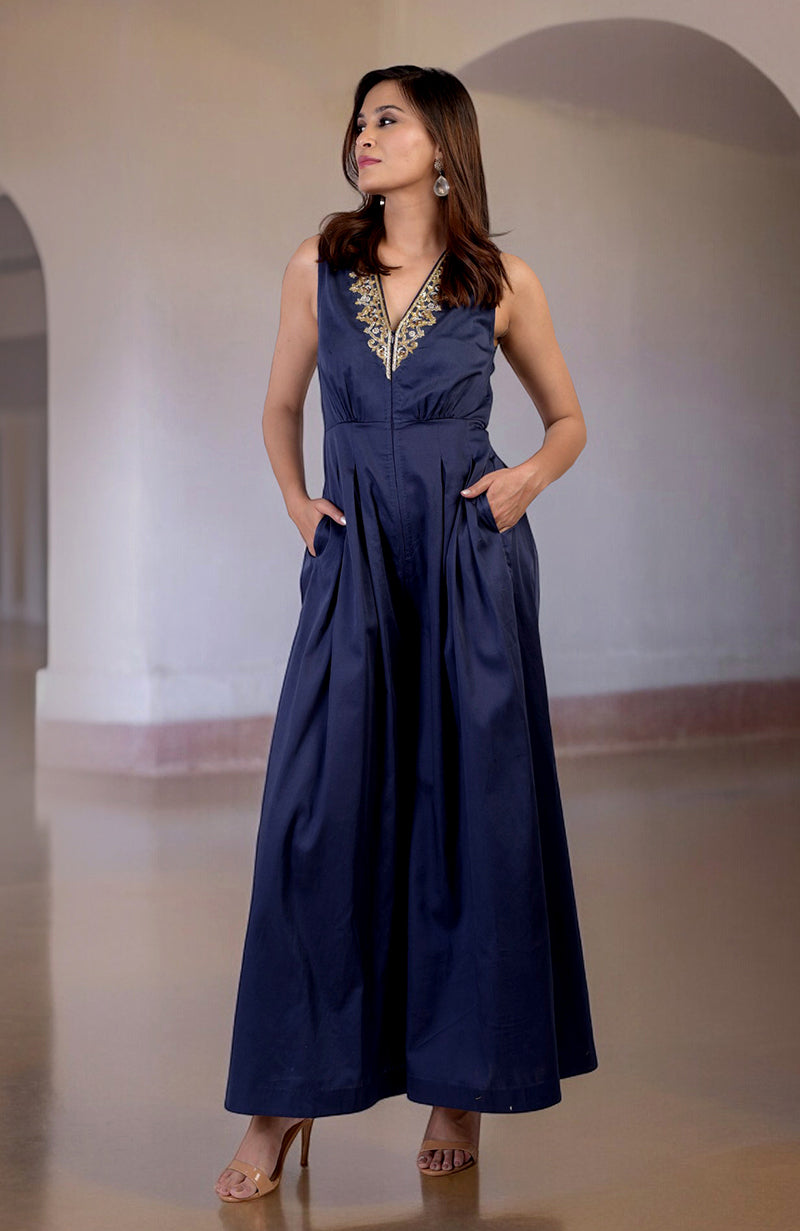 Blue jumpsuit with gold tilla hand embroidery, V-neck, and pockets.