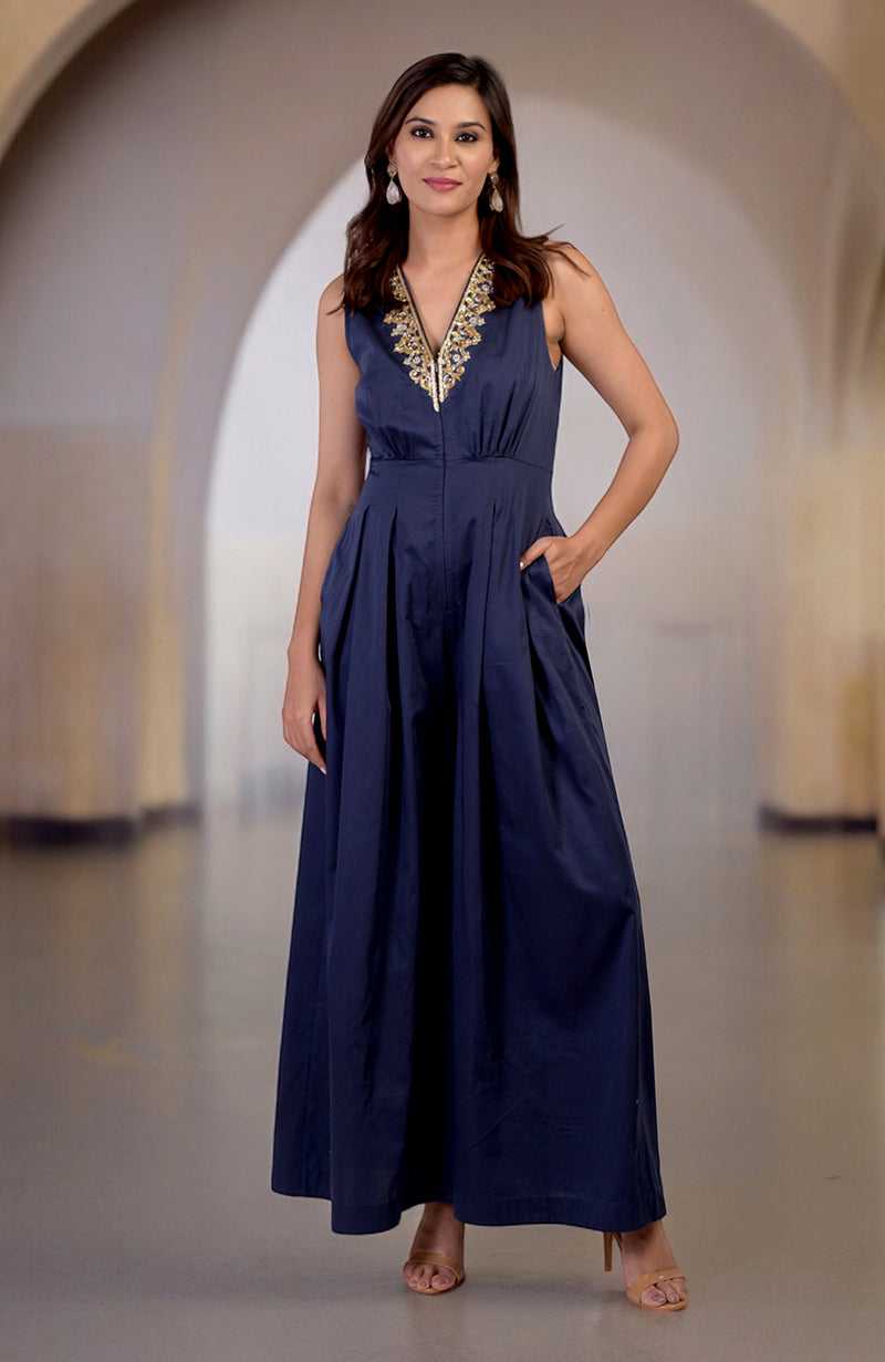 Blue jumpsuit with gold tilla hand embroidery, V-neck, and pockets.
