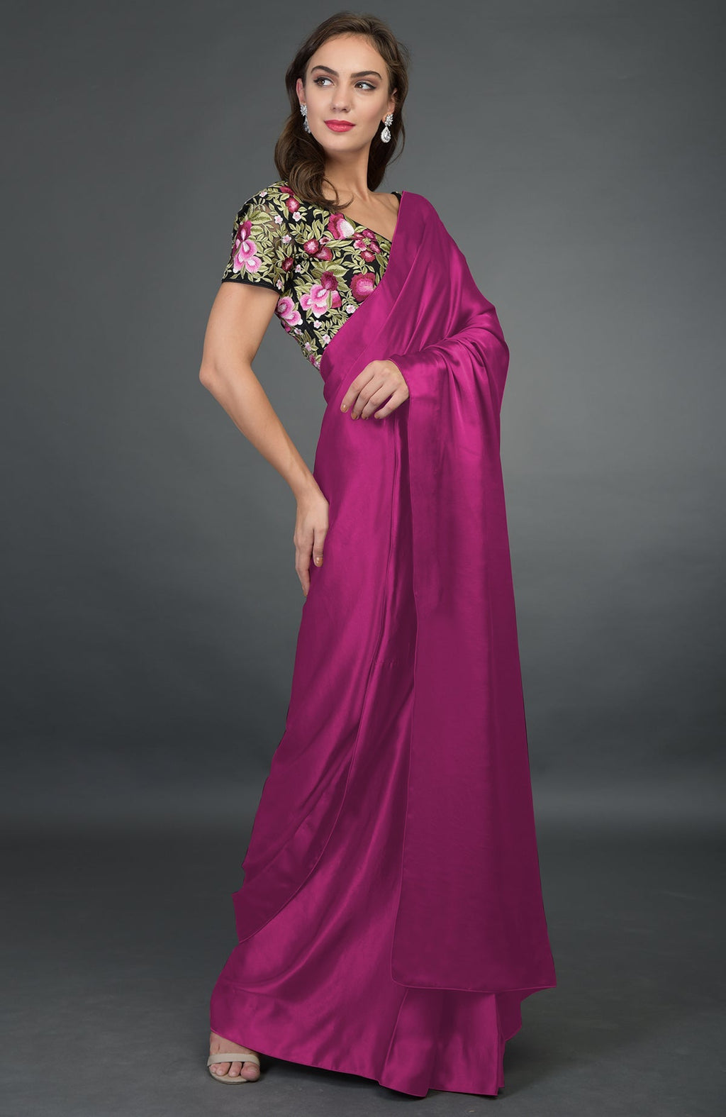 Raspberry satin silk saree with a black floral embroidered blouse.