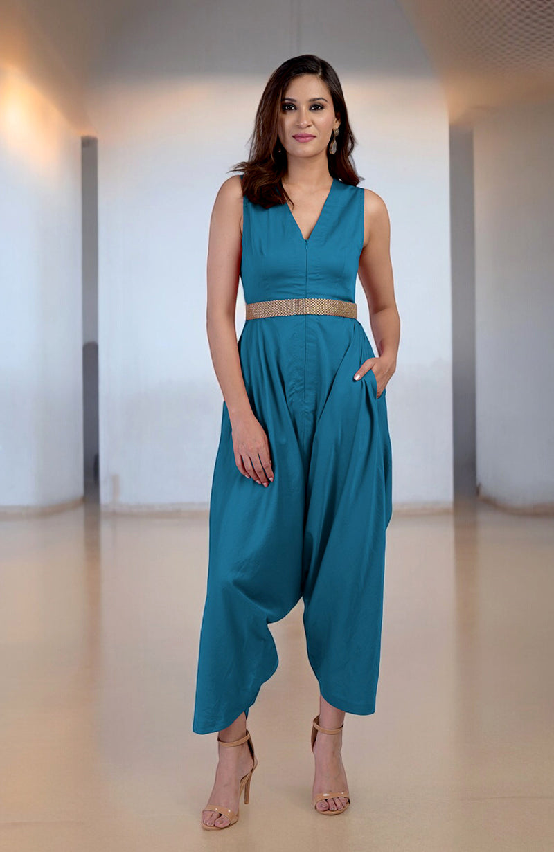 Celestial V-Neck Jumpsuit with a gold embroidered belt and afgani-style pants.