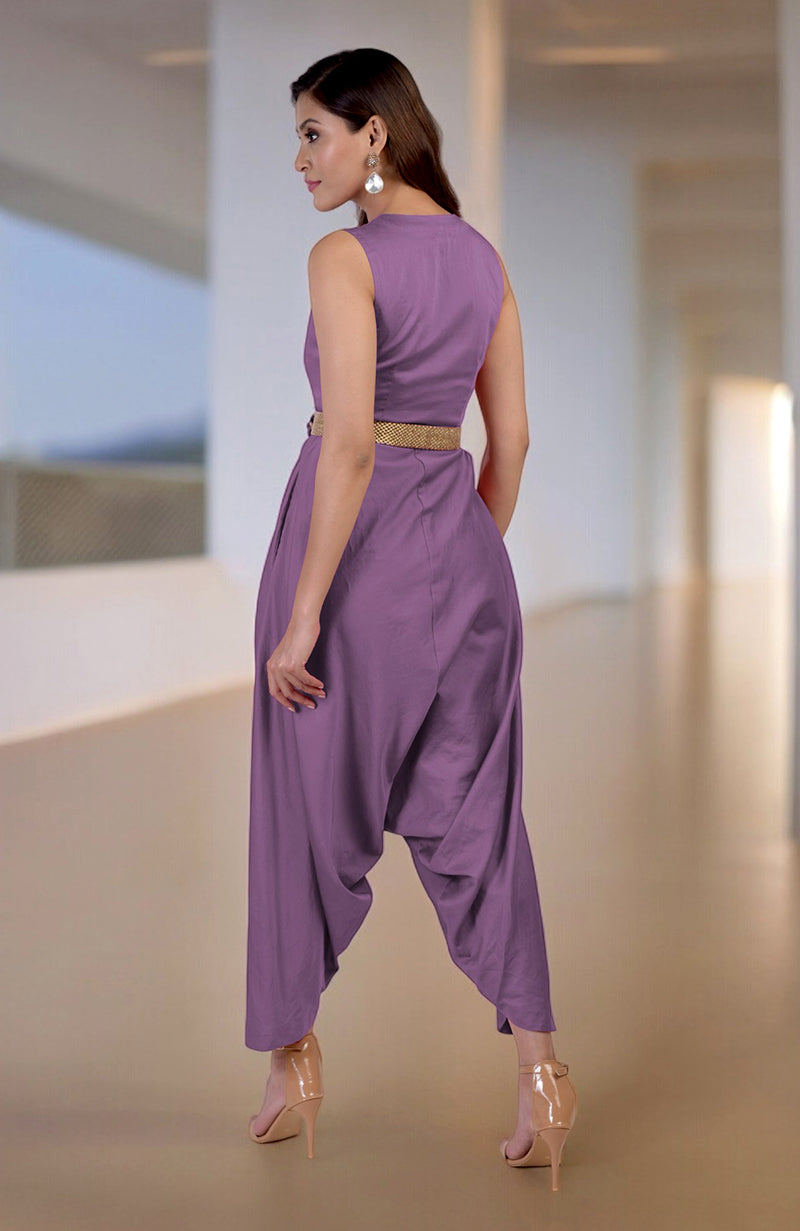 A woman models a lavender crystal V-neck jumpsuit with an embroidered belt and afgani-style pants.