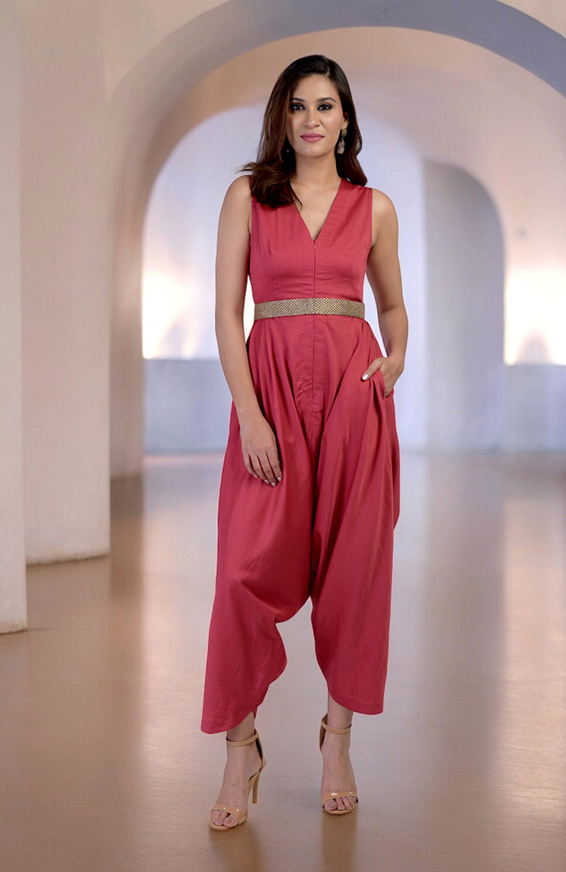 Red V-neck jumpsuit with a gold embroidered belt and side pockets.