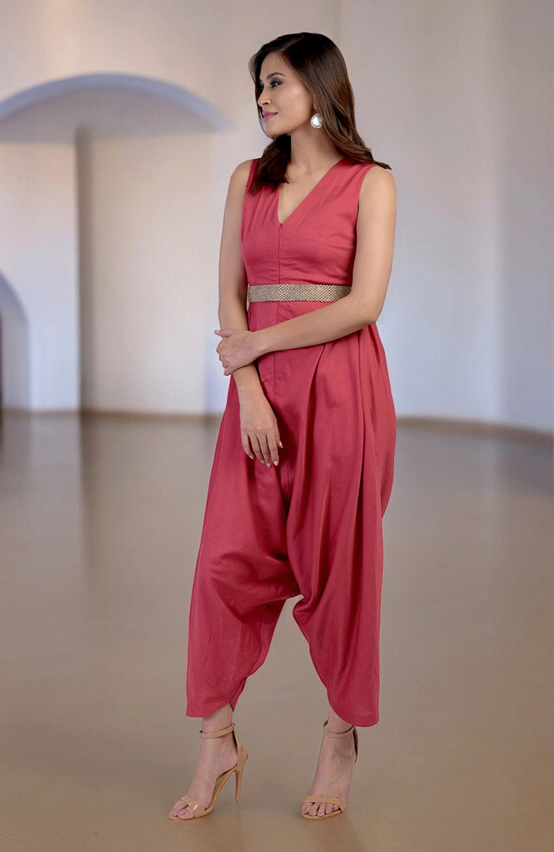 Red jumpsuit with a V-neck, afgani-style pants, and a dabka embroidered belt.