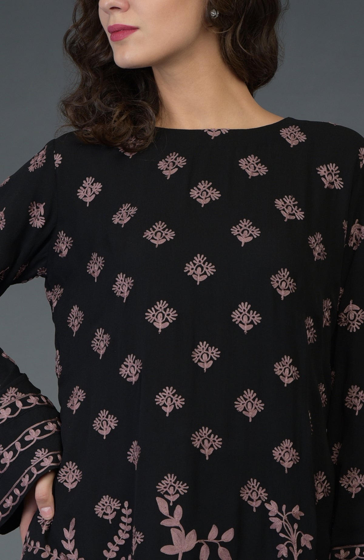 Black-mauve Parsi embroidered tunic suit with a woman wearing it.