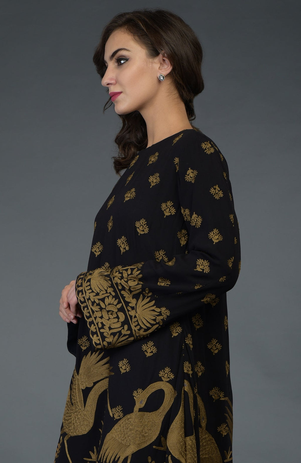 Black-beige gold Parsi embroidered tunic suit with crane and floral motifs.