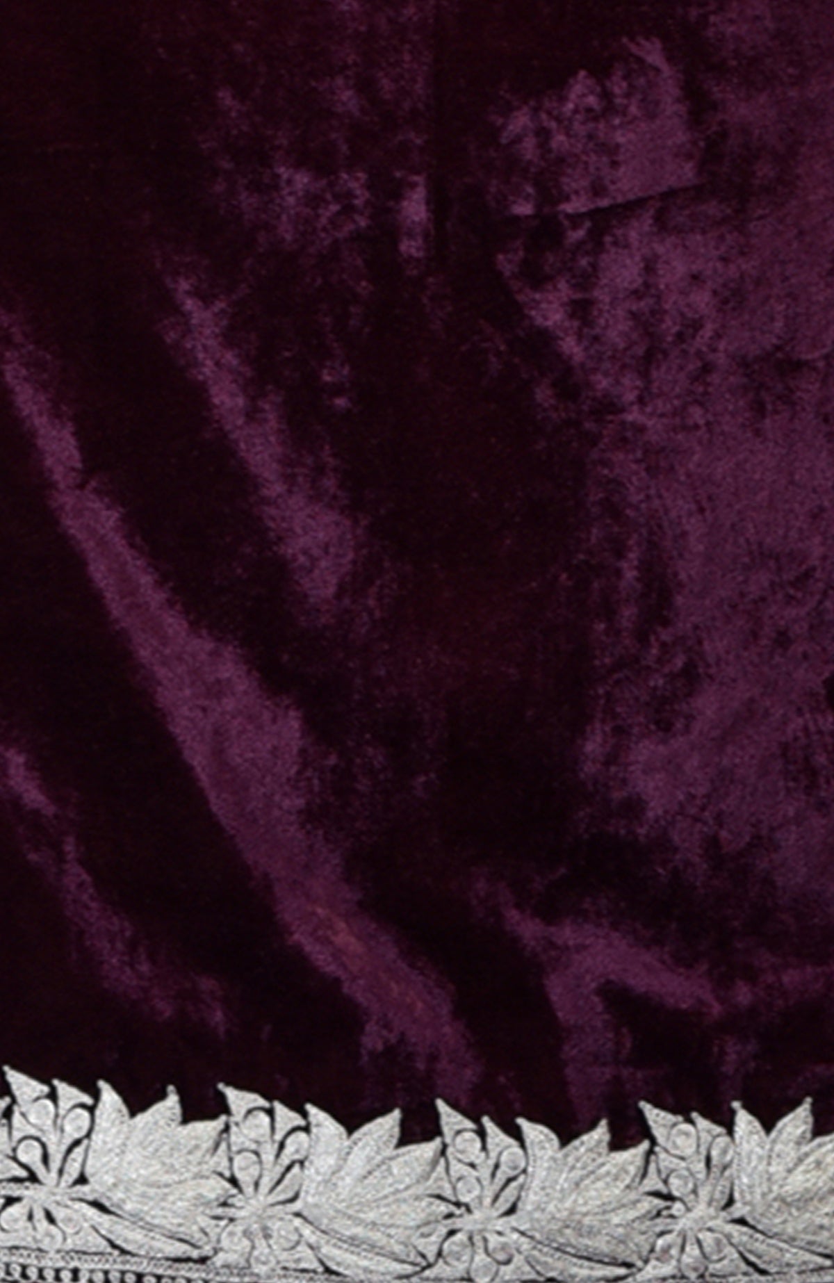 Dark plum silk velvet fabric with silver Tilla floral embroidery along the bottom edge.