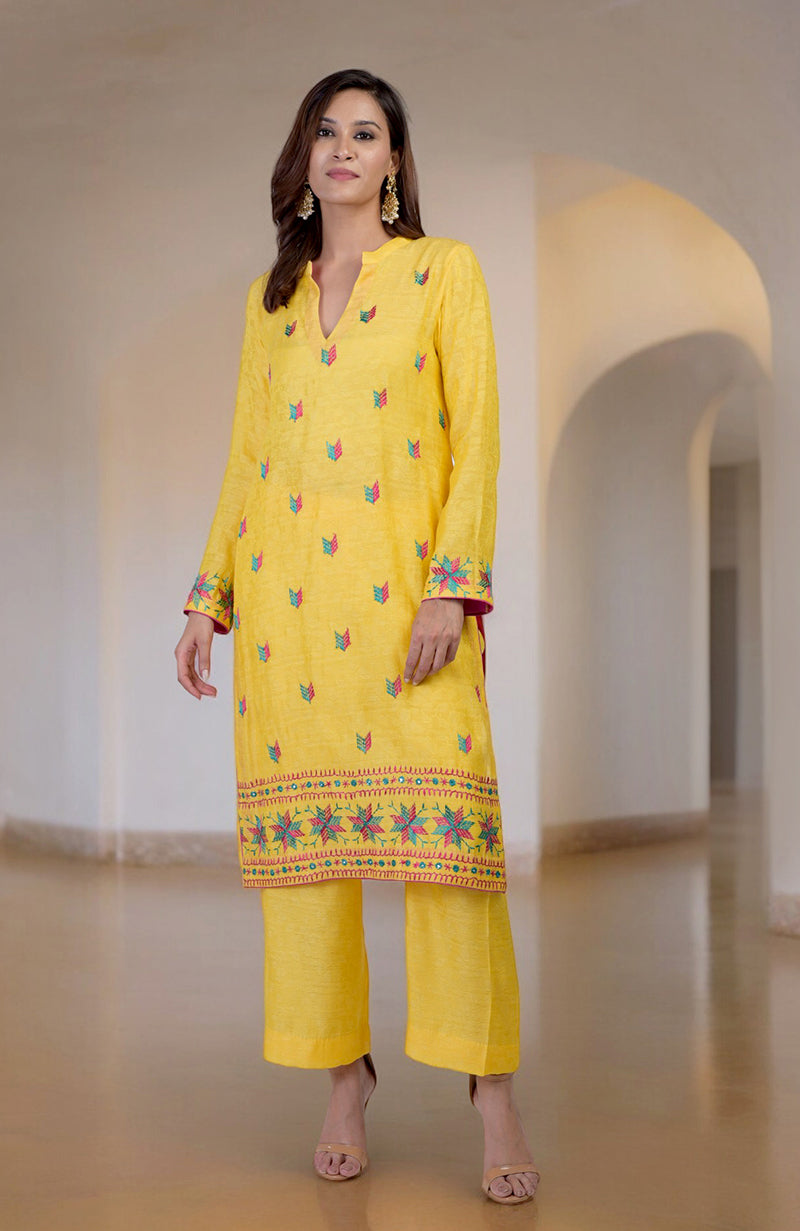 Yellow Phulkari embroidered kurta set with a V-neckline and wide-leg pants.