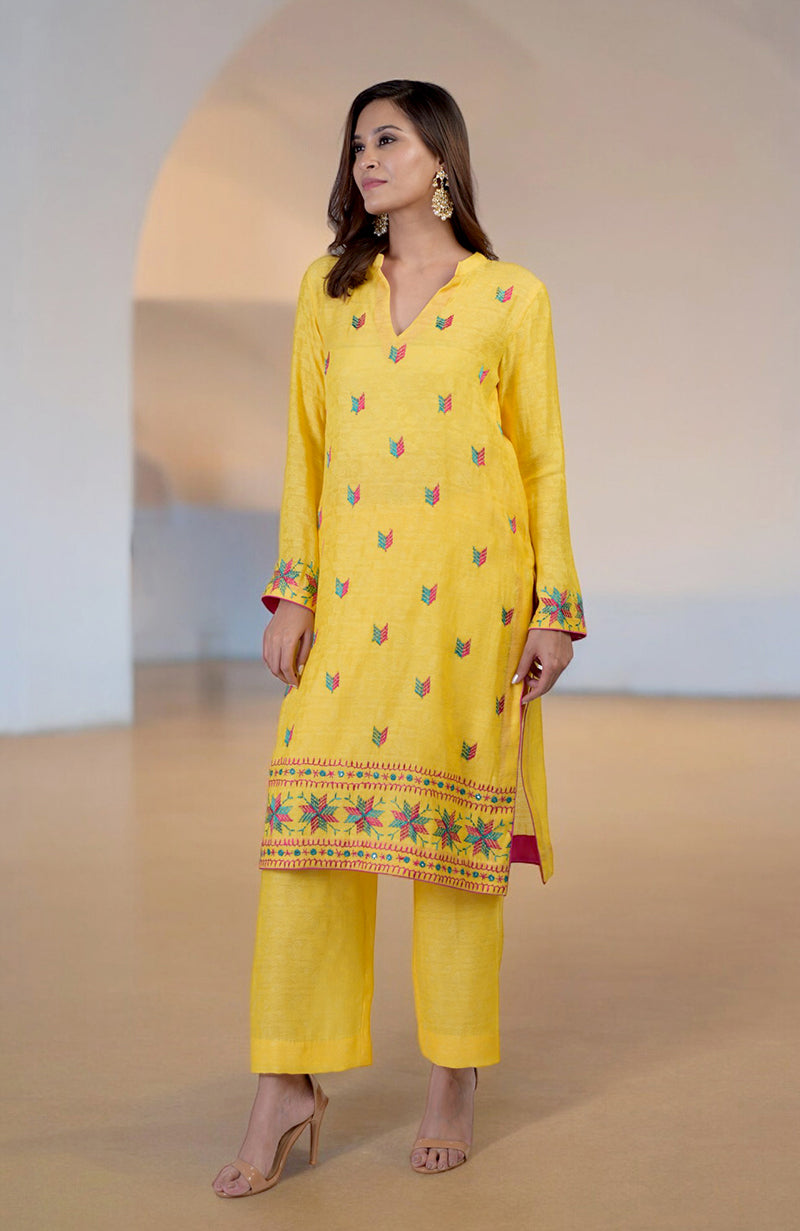 Yellow Phulkari embroidered kurta set with a V-neckline and wide-leg pants.