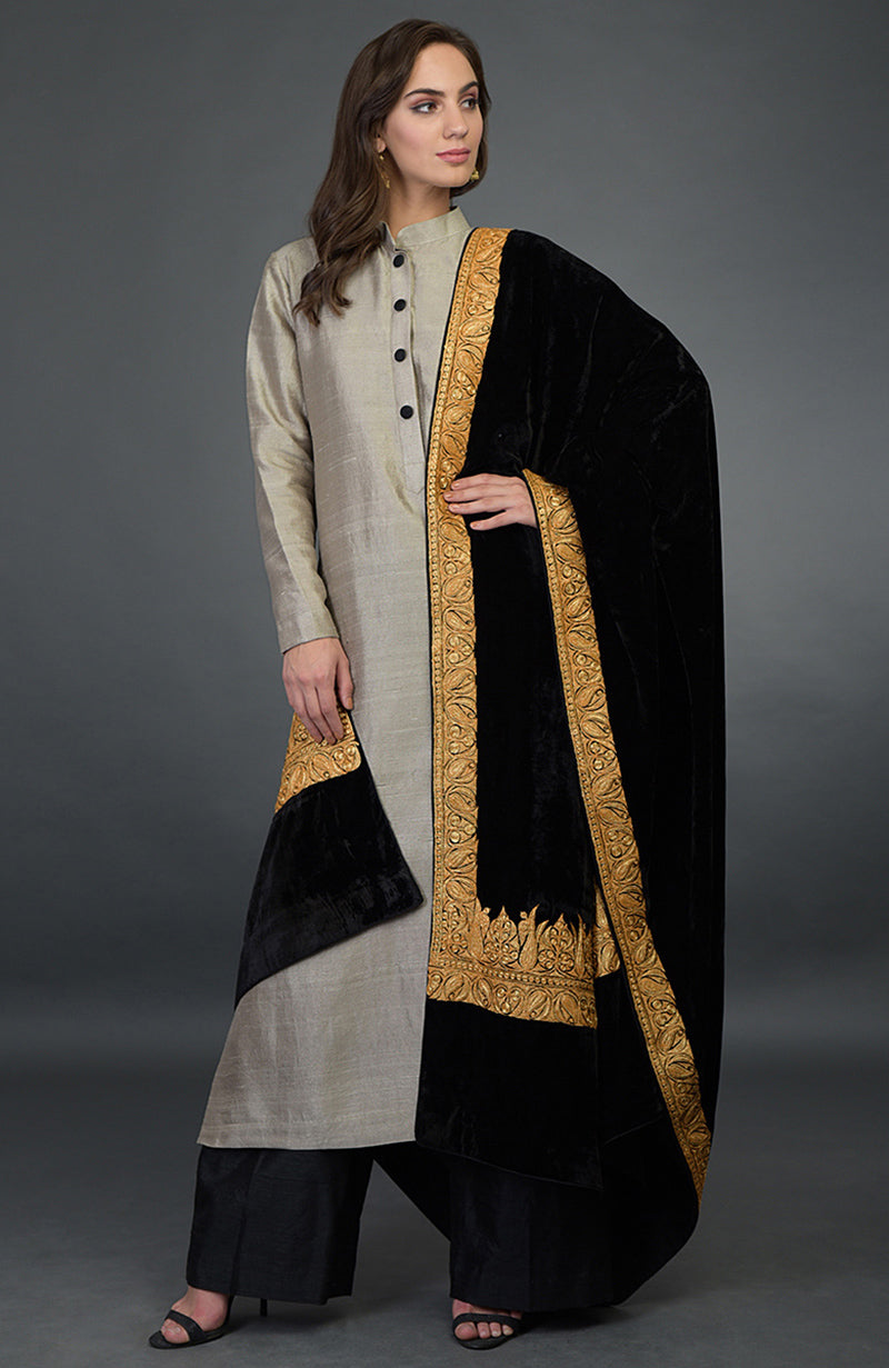 A woman models a beige kurta, black palazzo pants, and a black embroidered dupatta.