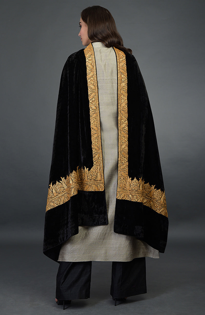 A woman models a black Kashmiri Tilla embroidered dupatta with a beige palazzo suit.