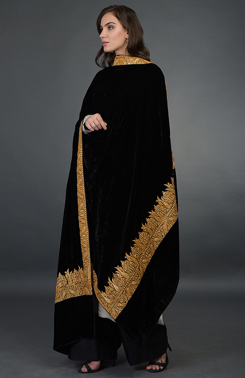 A woman models a black velvet dupatta with gold embroidery over a black palazzo suit.