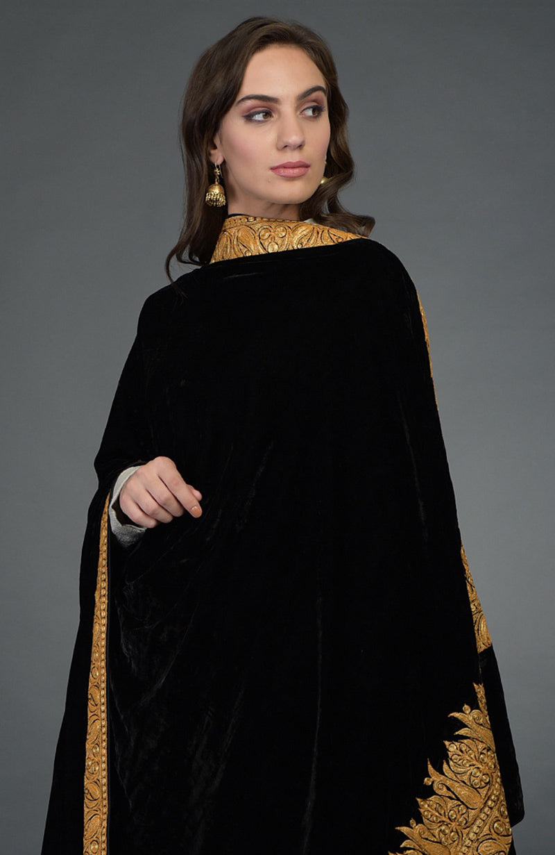 A woman models a black velvet dupatta with gold Kashmiri tilla embroidery.