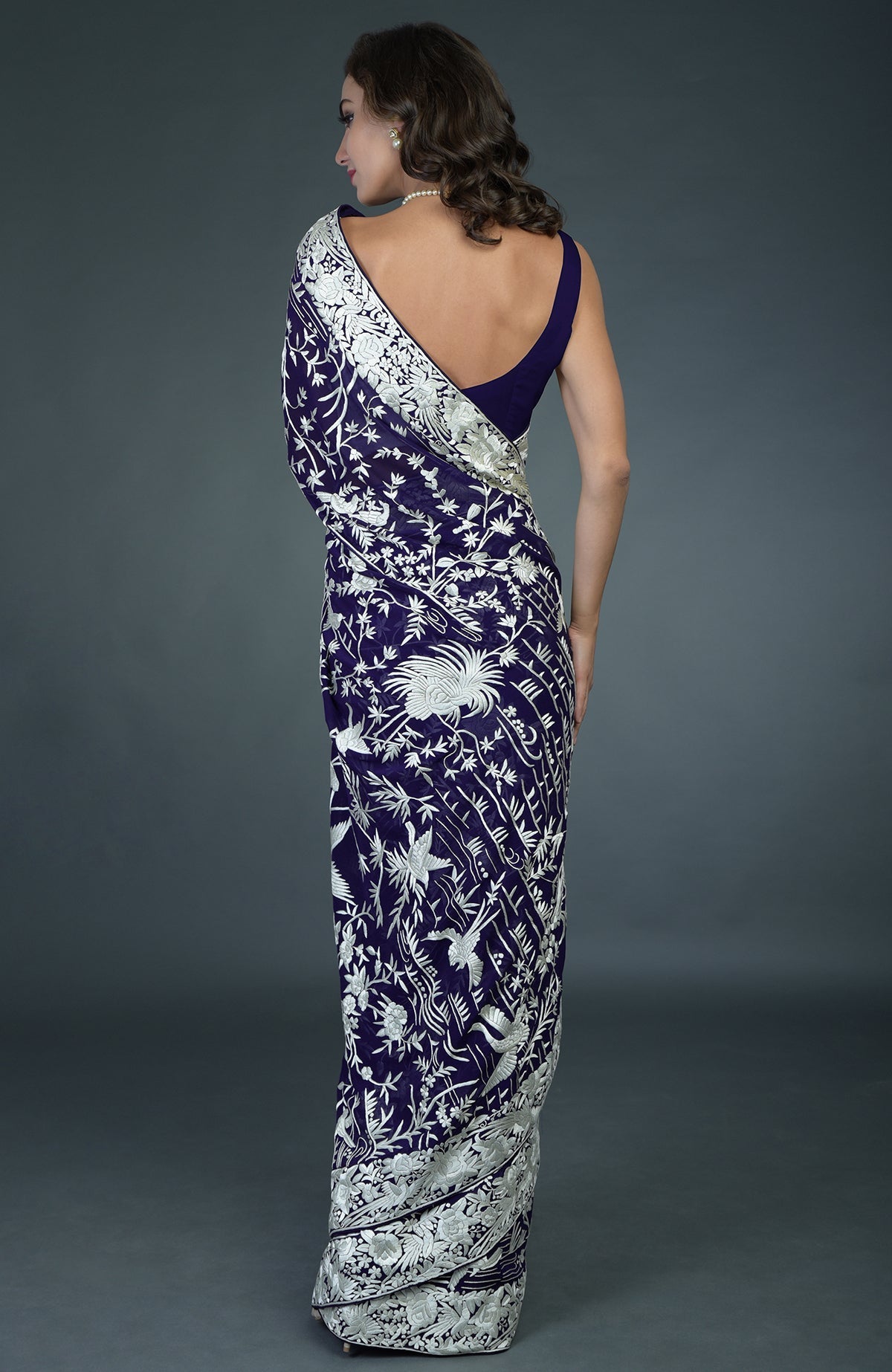 Navy blue Parsi Gara hand-embroidered saree with ivory bird and floral patterns.