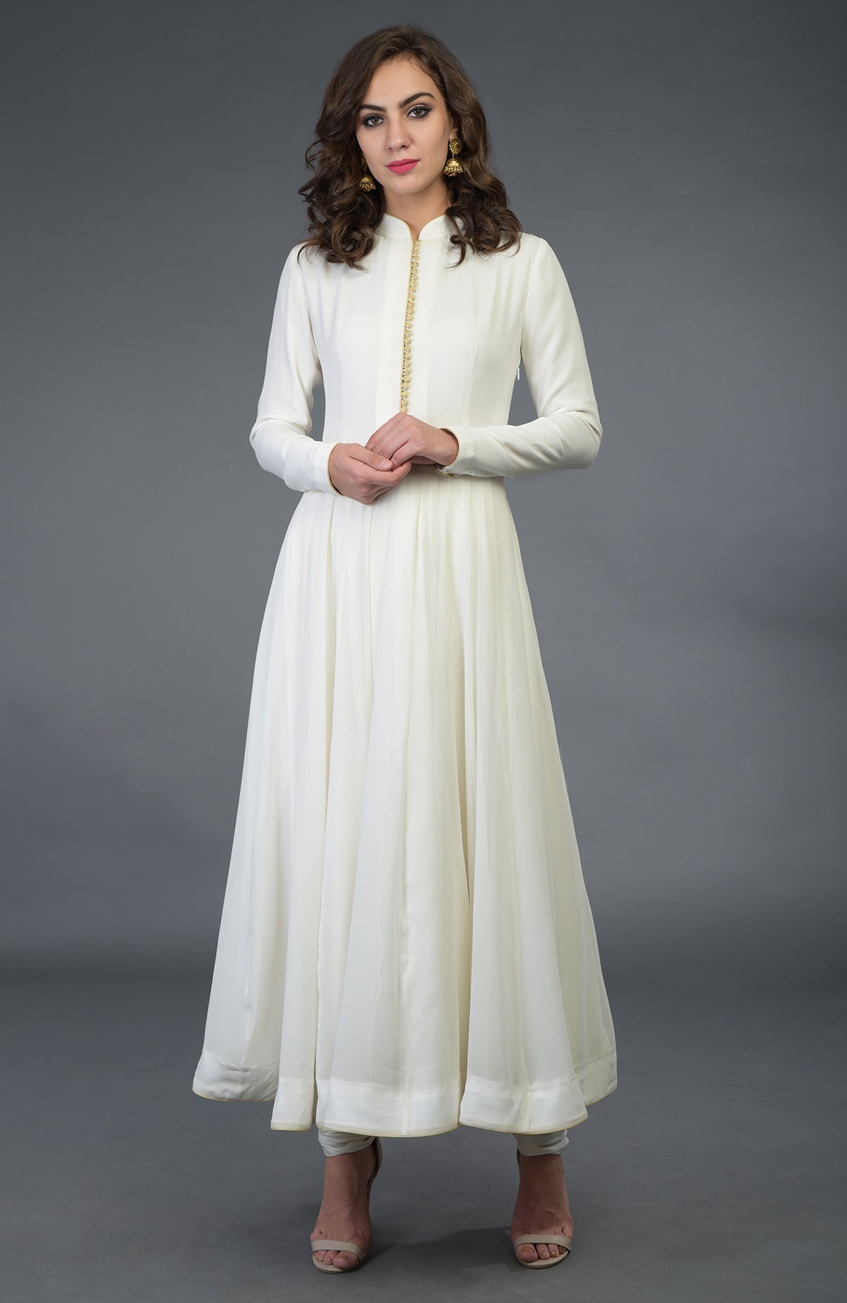 Anarkali suit in ivory with gold trim and matching churidar.