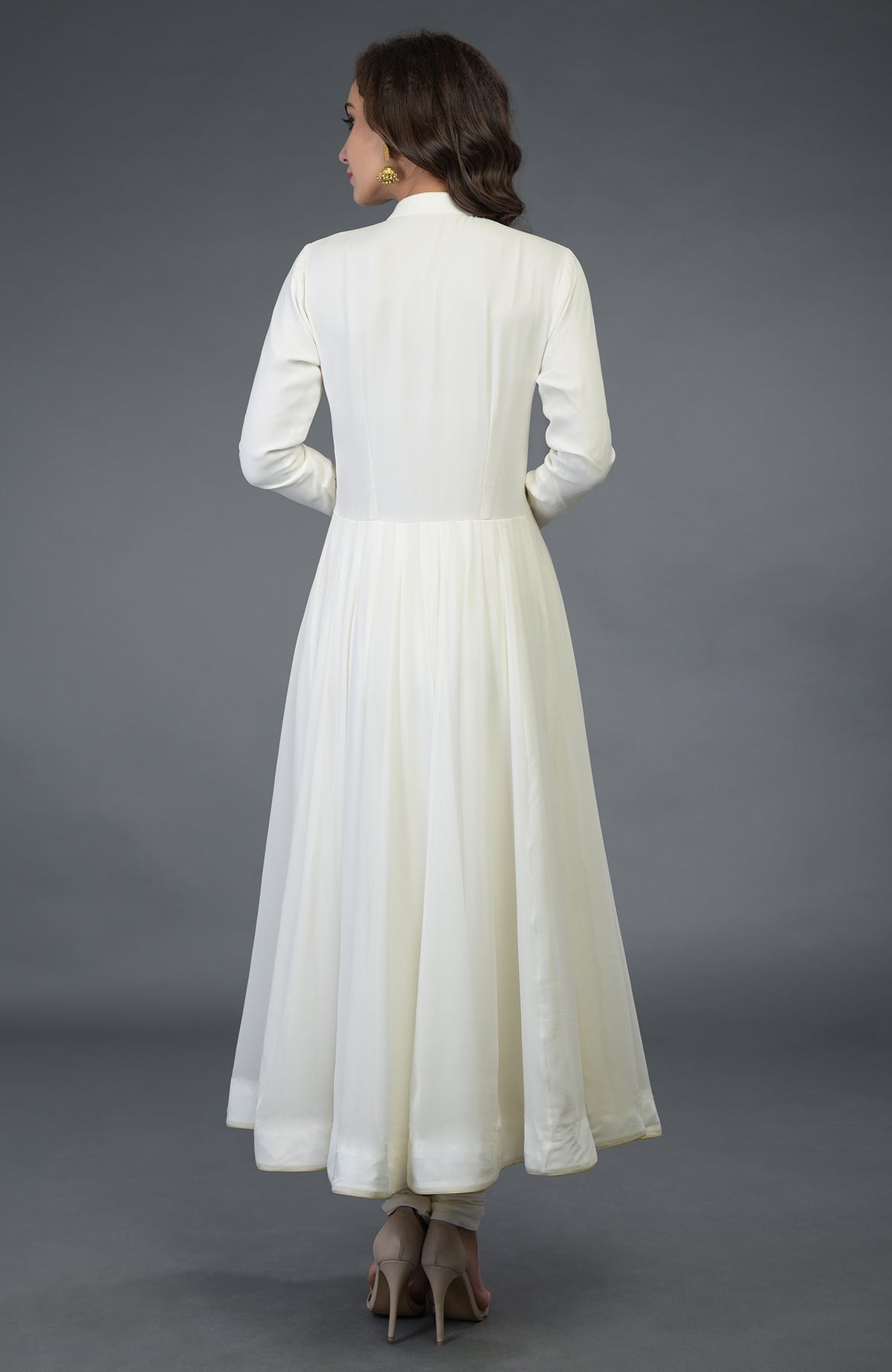A woman models an ivory-gold pure georgette anarkali suit with a band collar.