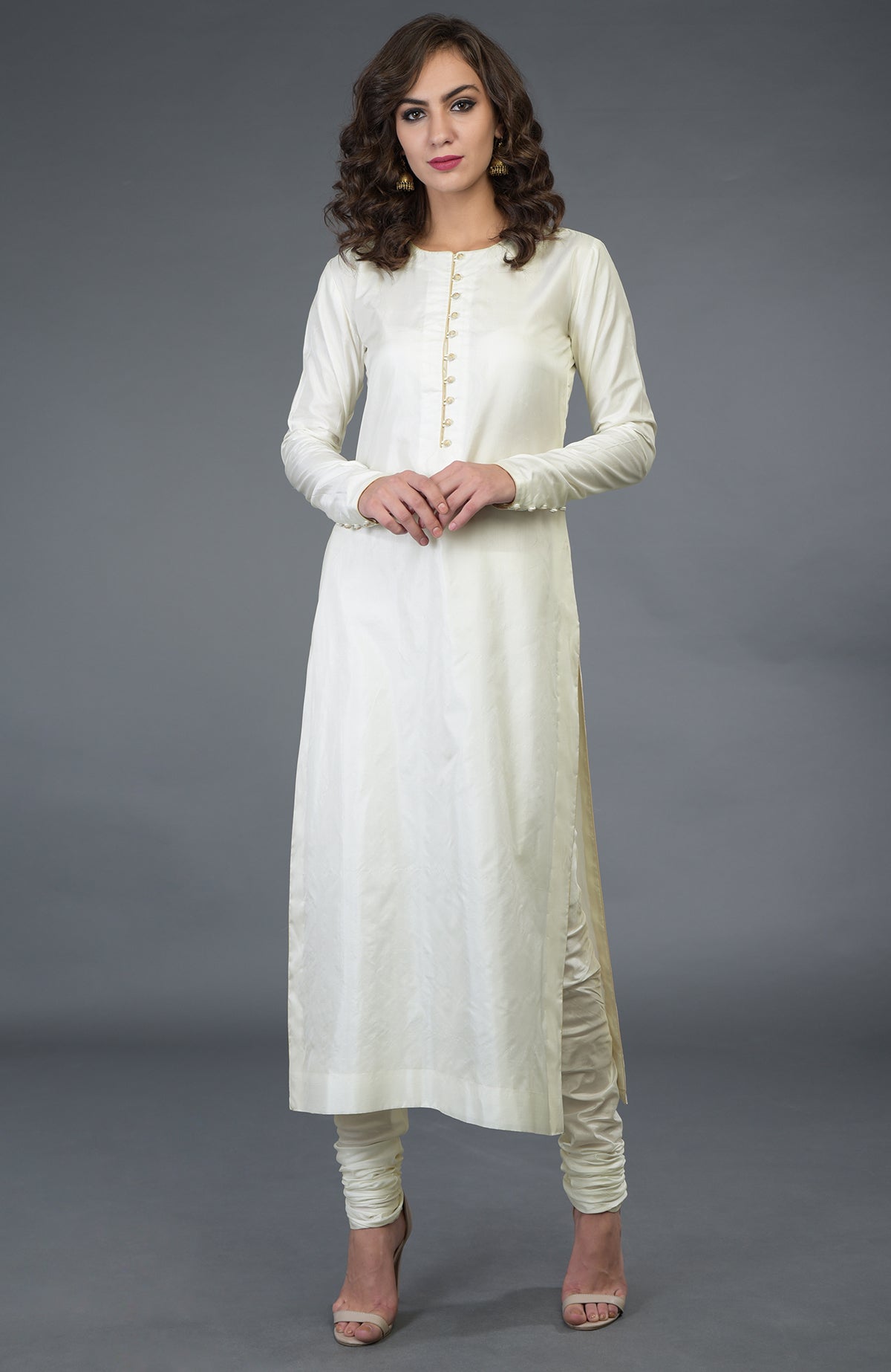 An ivory-gold pure silk suit with handcrafted buttons and trims.