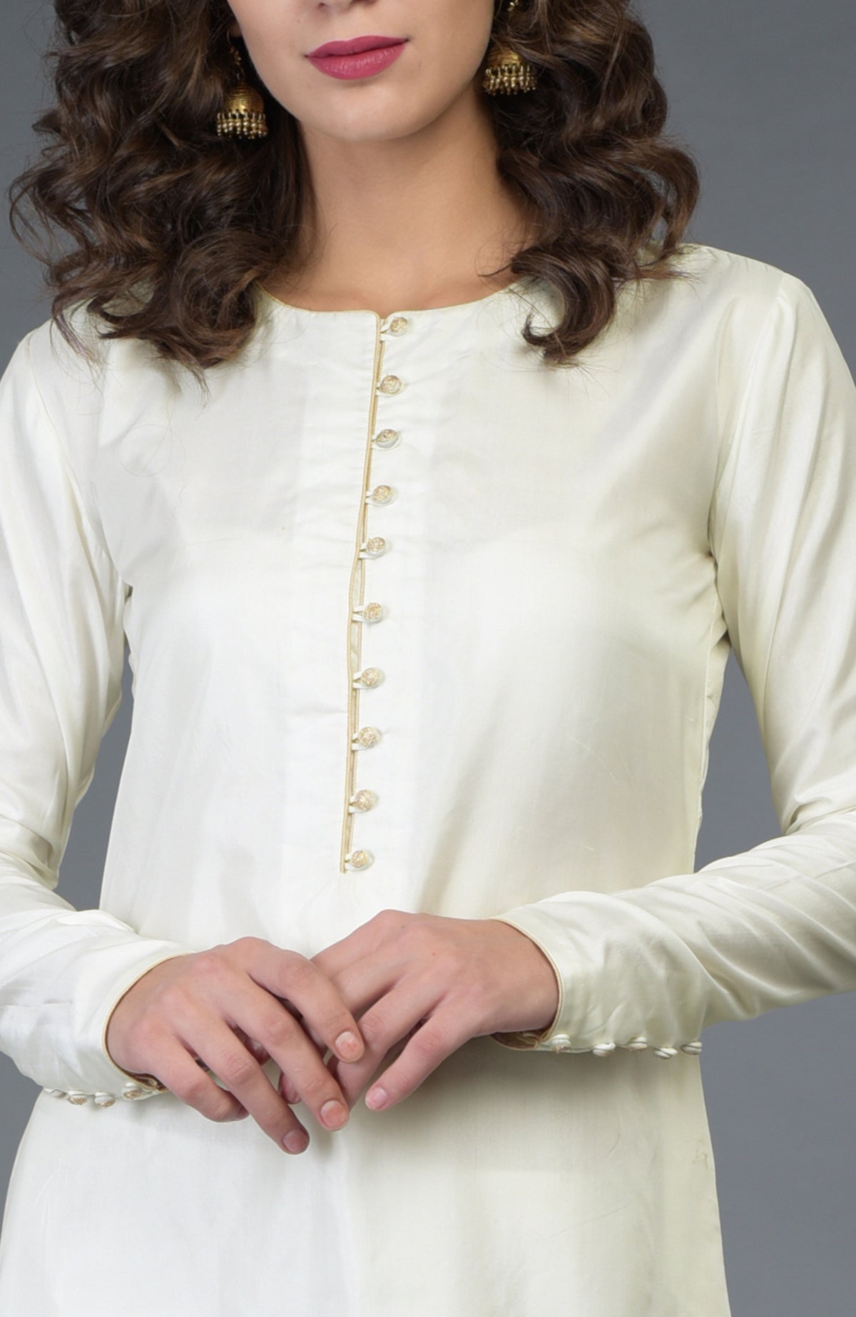 An ivory-gold pure silk suit with antique gold buttons and trims.