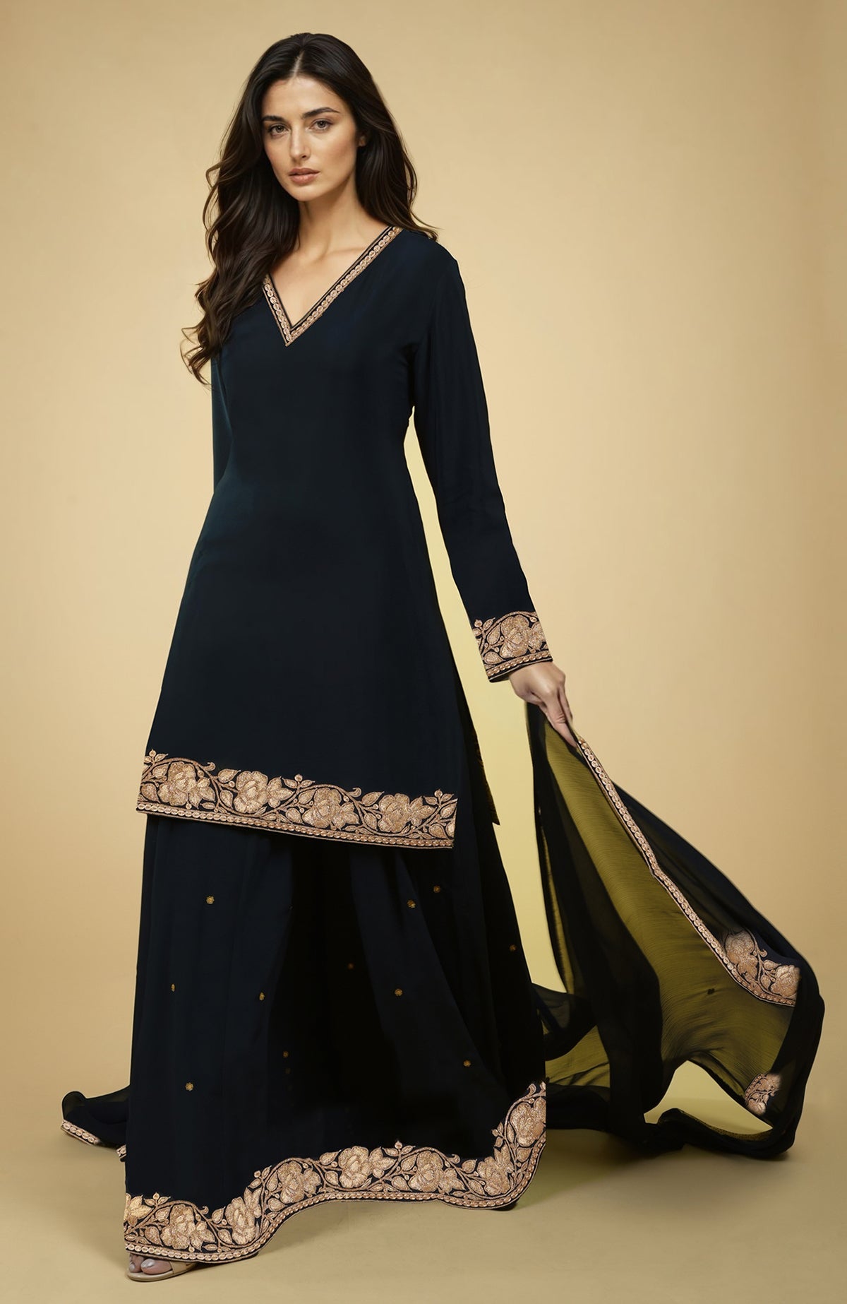 Black crepe sharara set with gold Kashmiri tilla embroidery on kurta, sharara, and dupatta edges