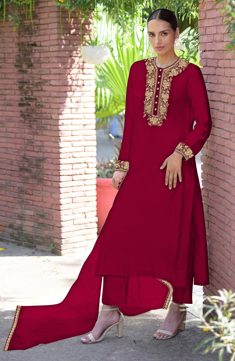 A woman models a red Kashmiri Tilla embroidered kurta set with gold accents.