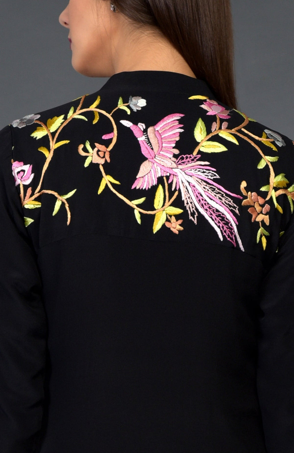 Black Parsi Gara embroidered jacket with a colorful bird and floral design on the back.