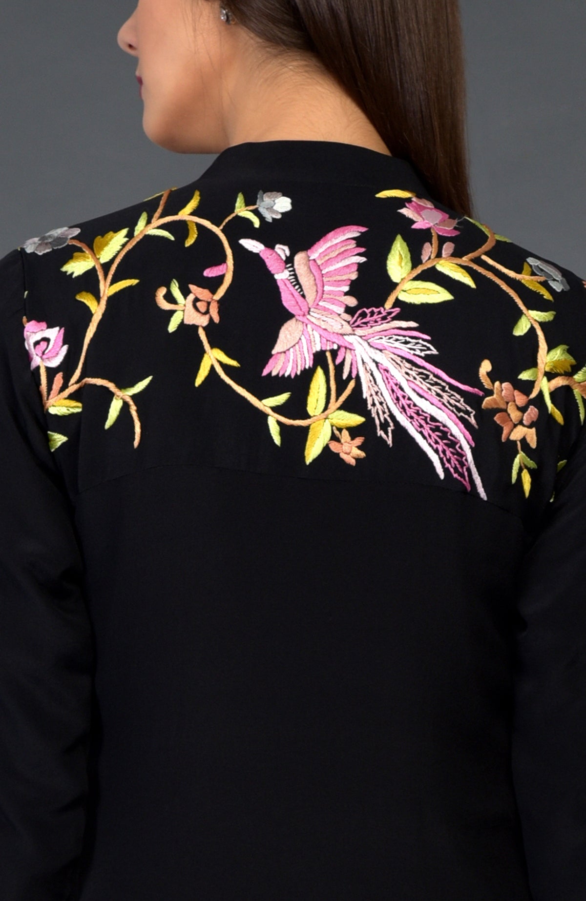 Black Parsi Gara embroidered jacket with a colorful bird and floral design on the back.