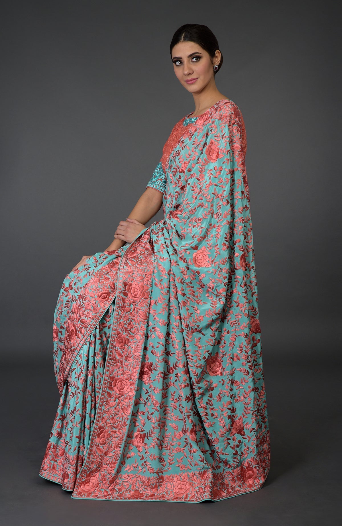 Aqua Parsi Gara hand-embroidered saree with peach floral patterns.