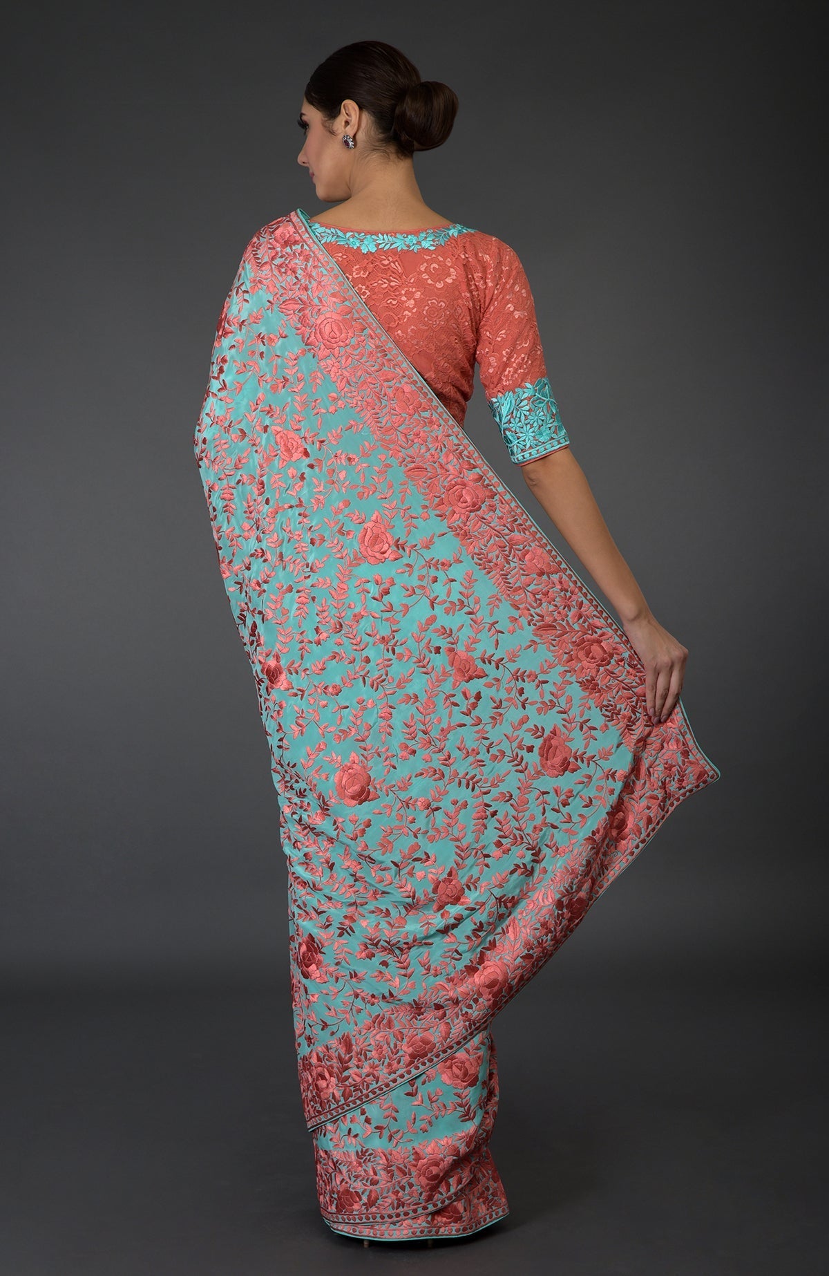 Aqua Parsi Gara hand-embroidered saree with peach floral patterns.