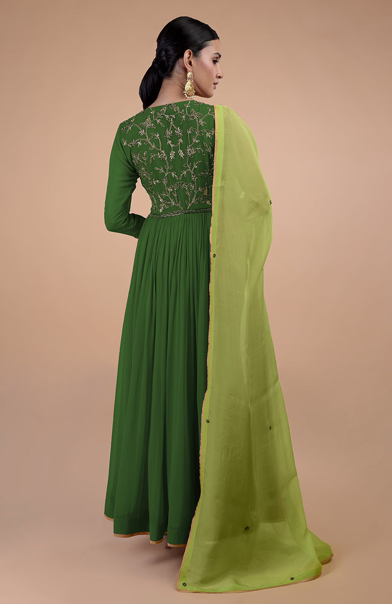 A woman models a green zardozi embroidered anarkali set with a light green dupatta.