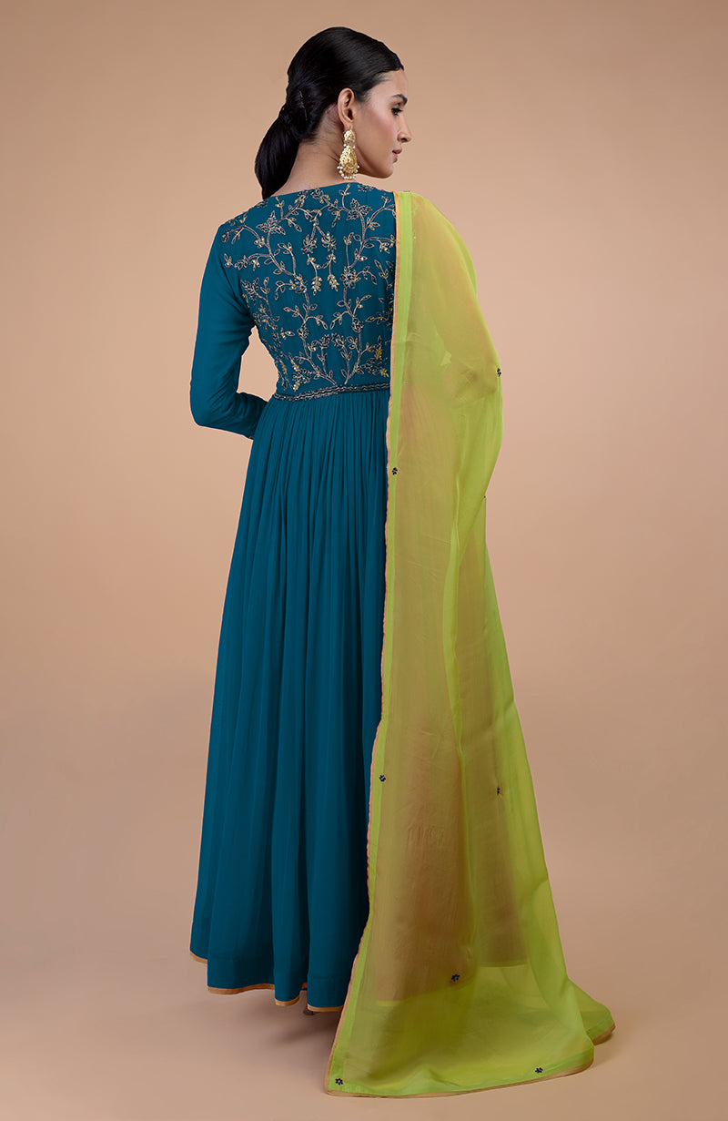 A woman models a peacock blue anarkali with green zardozi embroidery and a green dupatta.