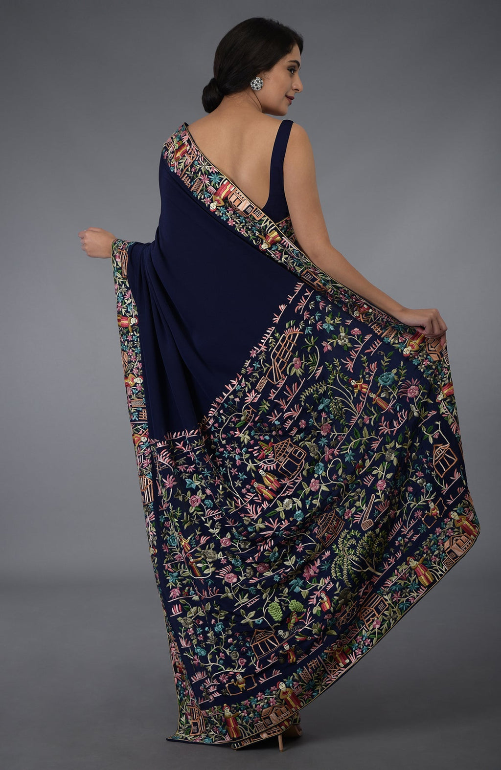Midnight blue Parsi Gara hand-embroidered saree with vibrant floral and scenic patterns.